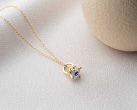 A delicate handmade Evil Eye pendant with intricate detailing, designed for spiritual seekers.