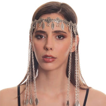 Woman wearing a silver headpiece with chains on a white background