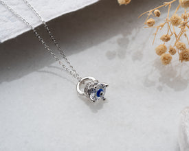 A silver protection necklace featuring a vibrant blue gemstone, perfect for layering or wearing as a statement piece.
