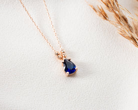 Dainty sapphire birthstone pendant for women, a timeless and elegant gift.