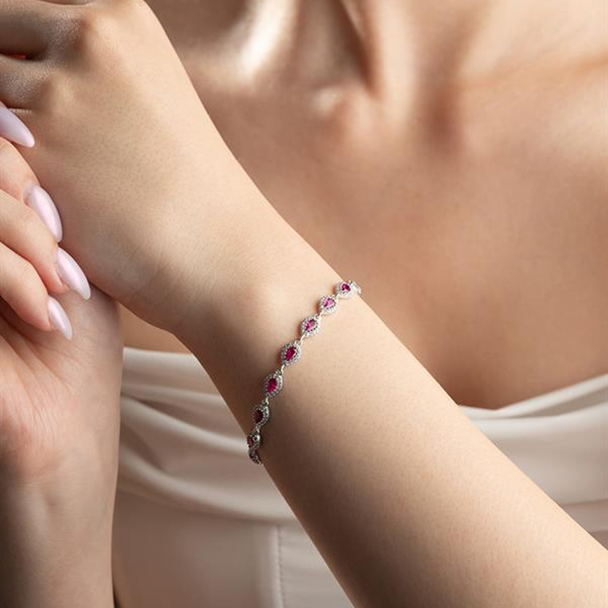 Bracelet with red gemstones on a person's wrist