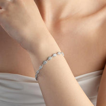 Silver bracelet on a person's wrist with a soft background