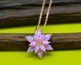 Handmade pink opal lotus pendant necklace in sterling silver, featuring a delicate fire opal gemstone.
