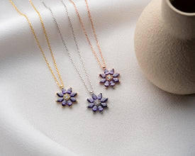 Minimalist silver flower pendant with deep purple amethyst, perfect for everyday wear.