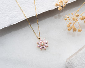 A soft and romantic pink tourmaline magnolia necklace, symbolizing love, strength, and femininity.