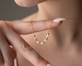 White gemstone necklace presented in a gift-ready box