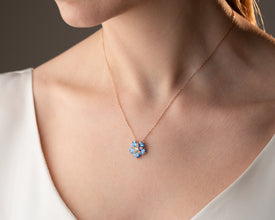 Model wearing minimalist ocean-inspired pendant necklace