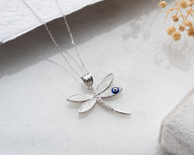 Layered necklace styling with dragonfly Evil Eye pendant