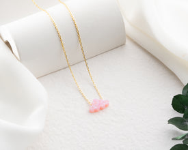 Pink opal gemstone jewelry with a delicate, ethereal cloud shape.
