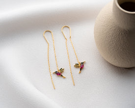 Nature-themed silver dangle earrings styled for daily wear