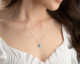 Nature-inspired opal bird pendant in sterling silver, perfect for free-spirited women.