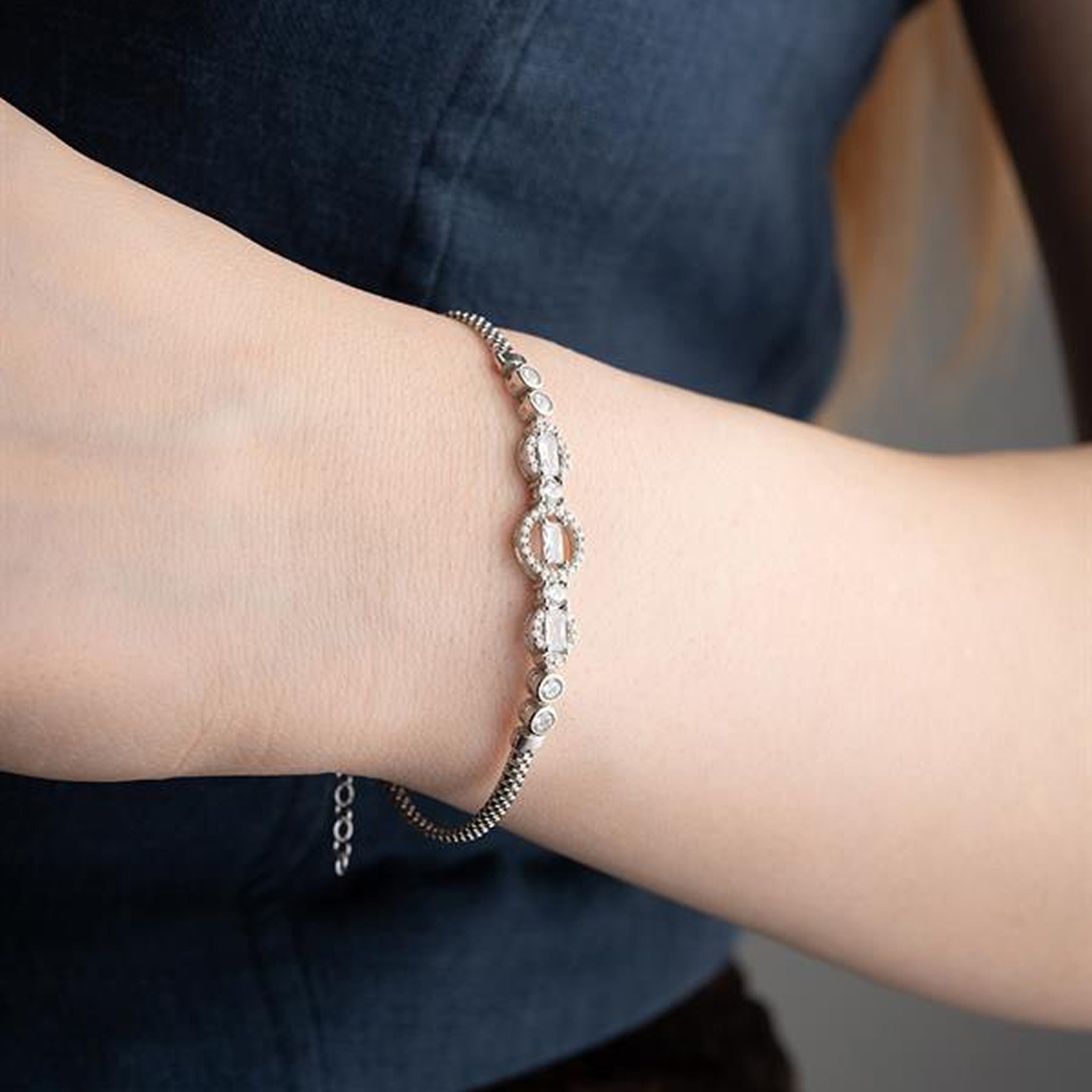 Close-up of a wrist wearing a bracelet with a blurred background