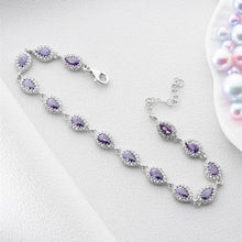Silver bracelet with purple gemstones on a white background