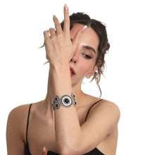 Woman wearing a bracelet with a black and white design on a white background