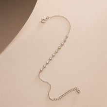 Silver bracelet on a beige background