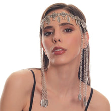 Woman wearing a silver chain headpiece on a white background