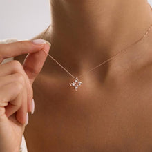 Rose gold necklace with a butterfly pendant being worn