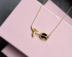 Close-up of a tulip-shaped silver pendant with iridescent gemstone glow.