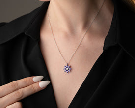 Elegant silver botanical necklace featuring a natural amethyst gemstone.