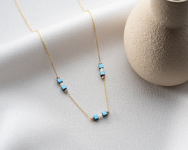 Hematite bar necklace layered with other silver necklaces