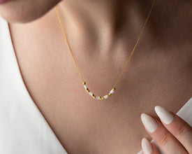 Model styling the handmade gold and gemstone necklace