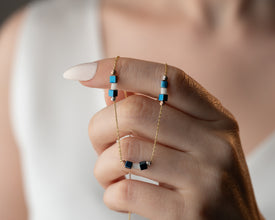 Hematite bar necklace stacked with other minimalist jewelry