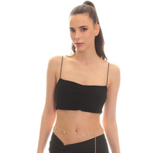 Woman wearing a black top and black pants with a gold chain belt on a white background