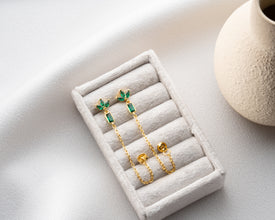 Clear crystal drop earrings arranged on meditation altar with sage and candles