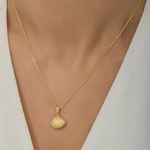 Gold necklace with a pendant on a mannequin