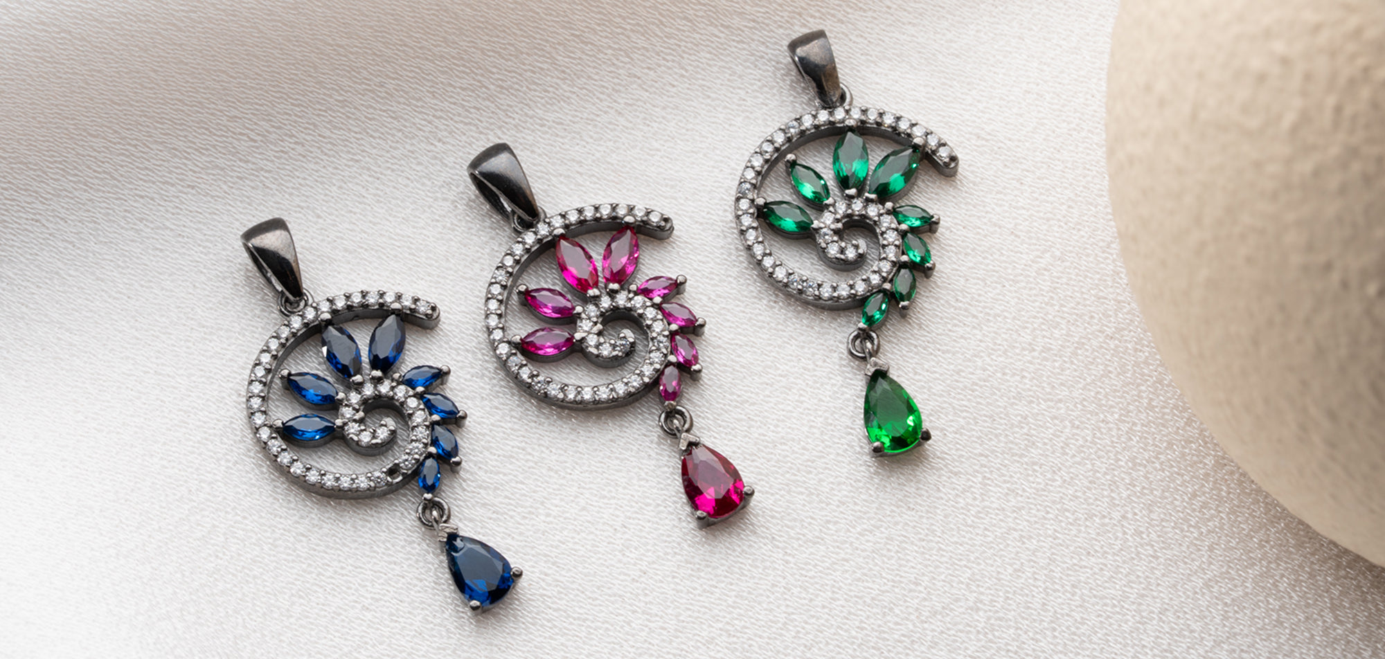 Black rhodium pendants with a gothic-style deep blue sapphire, emerald end garnet crystal pendants, perfect for women who embrace mystical elegance and dark beauty.