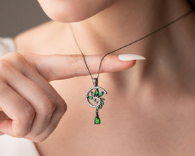 Macro shot of emerald trapped in black rhodium spiral cage