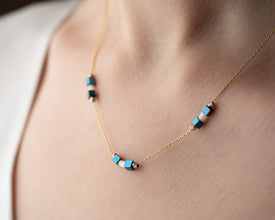 Lifestyle shot of minimalist hematite necklace outdoors
