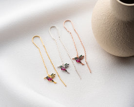 Side view showing flutter design of bird-inspired earrings