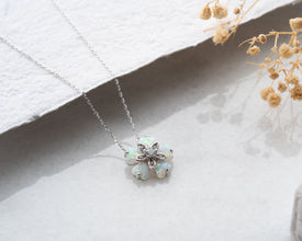 Handmade sterling silver opal floral necklace featuring an iridescent bloom pendant, inspired by natureÕs elegance.