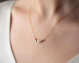 Close-up of smooth freshwater pearls on silk thread