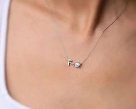 Close-up of tulip pendant with opal gemstone, elegant design