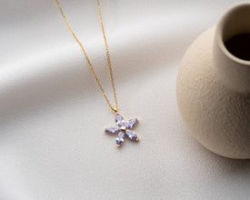 Minimalist nature-inspired flower necklace in sterling silver, a symbol of beauty and renewal.