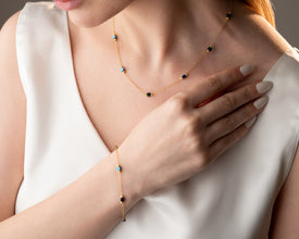 Close-up of handmade hematite cube necklace with celestial detail