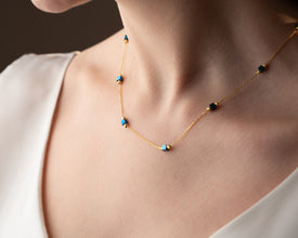 Woman smiling while wearing handcrafted hematite jewelry