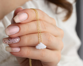 Minimalist opal cloud necklace with a dainty fire opal pendant.