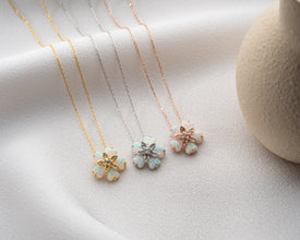 Ethereal flower necklace handcrafted with a glowing opal gemstone and delicate silver detailing.