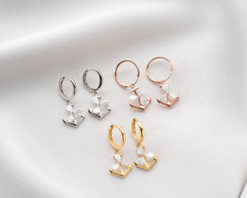 Travel-themed flat lay with nautical jewelry accessories