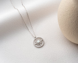 A luxury handmade celestial necklace featuring a glowing sunbeam motif, perfect for gift-giving.