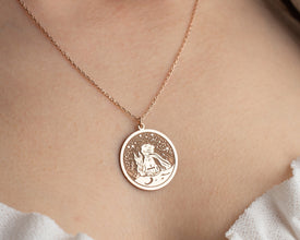 Handcrafted silver storybook pendant inspired by Antoine de Saint-ExupŽryÕs classic tale.