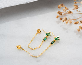 Luxury unboxing experience showing lotus earrings in embossed gift box