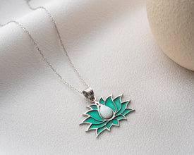 Nature-inspired stained glass pendant jewelry featuring opalescent hues and fine details.