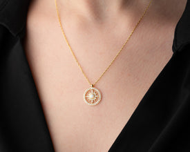 Minimalist gold and silver sun pendant necklace, designed for effortless everyday elegance.