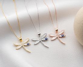 Dragonfly charm necklace placed on jewelry box for gifting