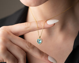 Close-up of a handcrafted aquamarine birthstone pendant in sterling silver.