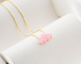 Dreamy celestial necklace with a glowing pink opal charm.